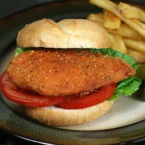 Crispy breaded chicken sandwich with tomato and fries