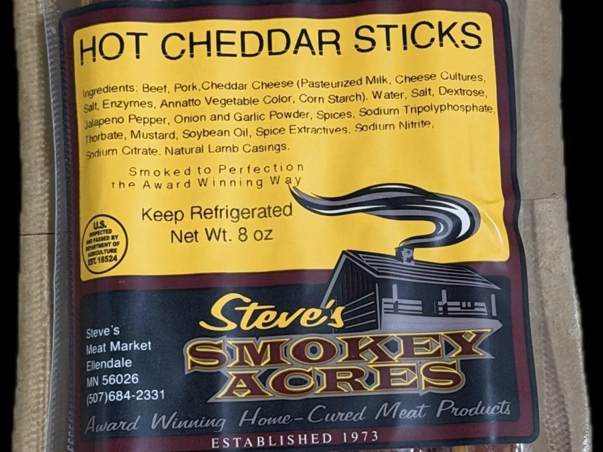 Vacuum-sealed package of hot cheddar meat sticks