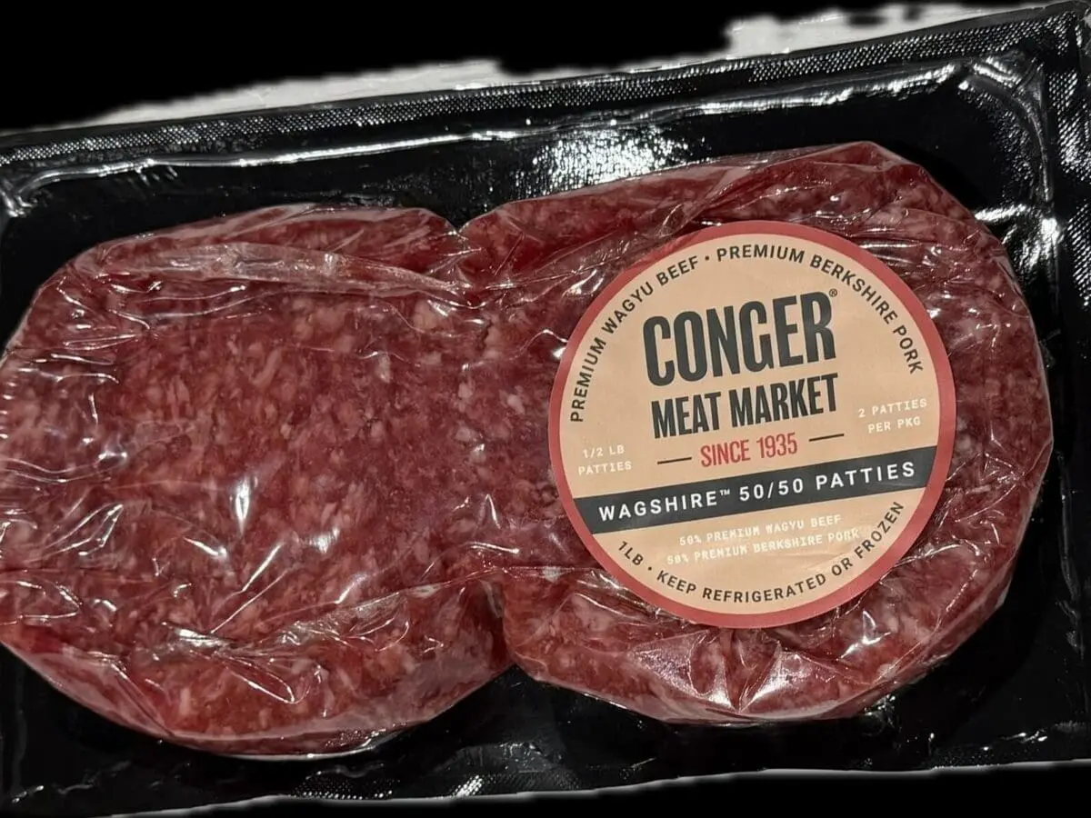 Packaged raw beef burger patties in tray