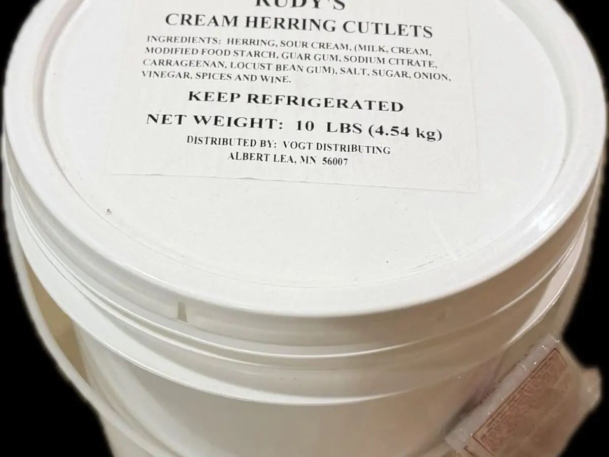 Stacked white buckets labeled Rudy's cream herring cutlets