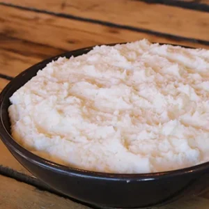 Bowl of cottage cheese on wooden table