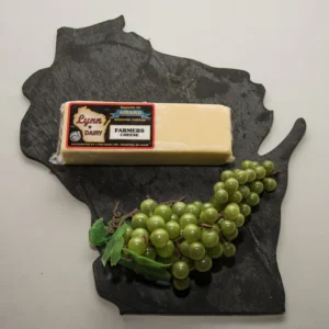 Block of cheese and grapes on slate