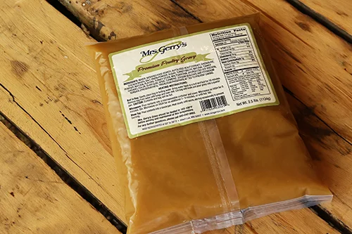 Packaged poultry gravy pouch on wooden surface