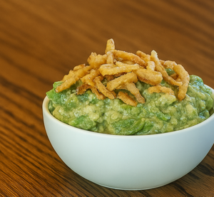Bowl of guacamole topped with fried onions