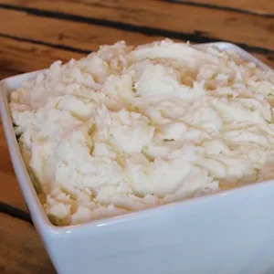 Creamy mashed potatoes in white square bowl
