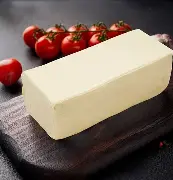 Block of butter on wooden cutting board
